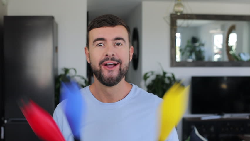 Man holding colorful juggling clubs