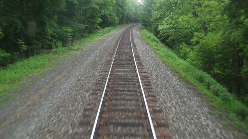 view of moving train tracks from the back of metro car window new york jersey transit north (riding subway travel transportation) gravel rail track bed
