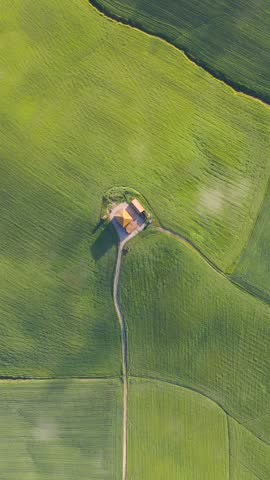 Top View Of Country Farm House Amidst Green Rolling Hills In Tuscany, Italy. Aerial Ascending Shot
