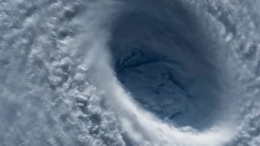 Satellite view of a massive hurricane eye from space. Giant tropical cyclone, typhoon or tornado storm spinning with dense white clouds in the atmosphere.