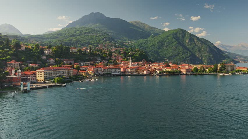 Scenic aerial view of Menaggio town on the shore of Lake Como, Italy. Beautiful resort destination features traditional houses and majestic mountains. Village of Menaggio, Como Lake
