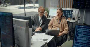 Caucasian Male Developer and Female Engineer Discuss Code Together on a Laptop in a Modern Tech Office, Discussing Mobile Ecommerce App Logic, AI Features, Cybersecurity and Ux Design. Using Computer - Powered by Shutterstock - Get 15% off with code: PIKWIZARD15