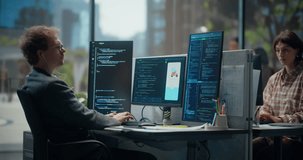 Young Male Programmer Typing and Coding in Bright Office, Using Multiple Displays to Test Mobile App Ui, Debug Backend Script, Automation Flow, With Light-skinned Young Female Designer. Working Using Computer - Powered by Shutterstock - Get 15% off with code: PIKWIZARD15