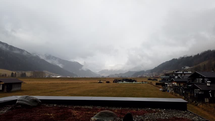 Time lapse in a valley in the Austrian Alps. Fog and clouds turn into blue skies and a sunny day.