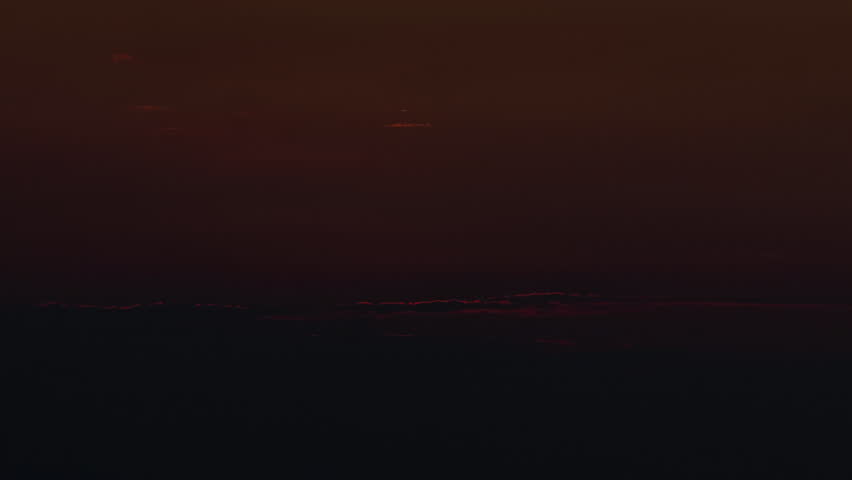 Mesmerizing ocean time-lapse capturing the transition from daylight to sunset, twilight, and night over a coastal horizon. Dynamic cloud movement, changing sky colors, and reflections across the water create a stunning natural landscape. Ideal for travel, nature, weather, environmental, meditation, and cinematic storytelling projects.