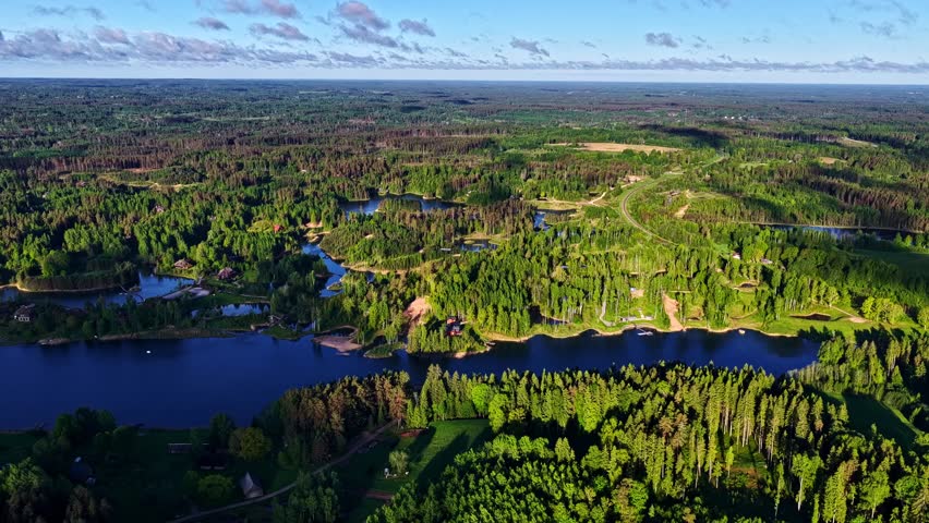 Expansive forest landscape with multiple lakes, panoramic aerial perspective, vibrant green woodland.