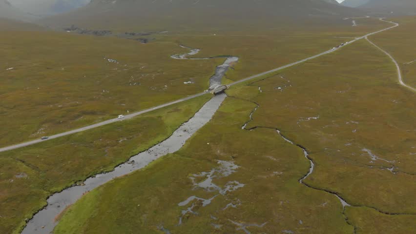 Drone reveal of Buachaille Etive Mor, A82 road and river, Glencoe.