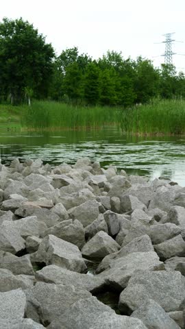 Calm view by the lake with rocks in the foreground