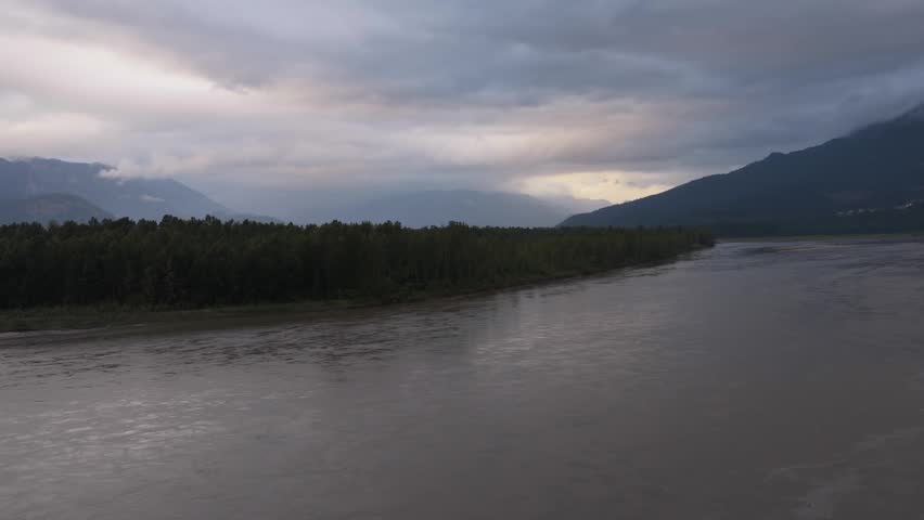 Aerial View of the Majestic Fraser River Winding Through Forests and Mountains in Chilliwack, British Columbia
