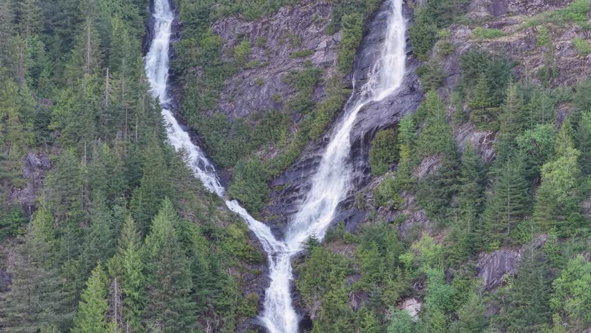Spectacular Multiple Waterfalls Cascading Down a Lush Green Forested Mountain in British Columbia, Canada