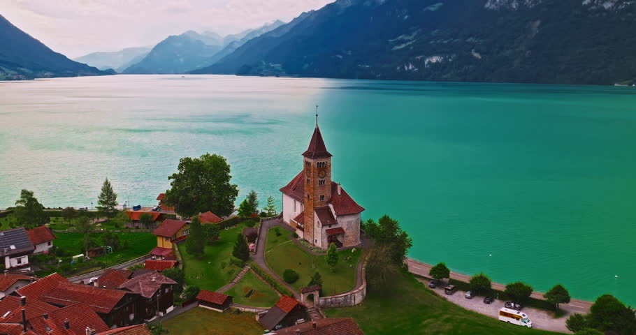 Aerial view of traditional Swiss houses rooftops on the shore of a lake between the Alps in Brienz, Switzerland