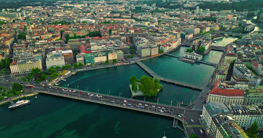 Establishing shot of Geneva city. Aerial view of the Swiss lake town. Rooftops of houses and the lake bay