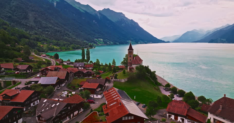 Aerial view of traditional Swiss houses rooftops on the shore of a lake between the Alps in Brienz, Switzerland