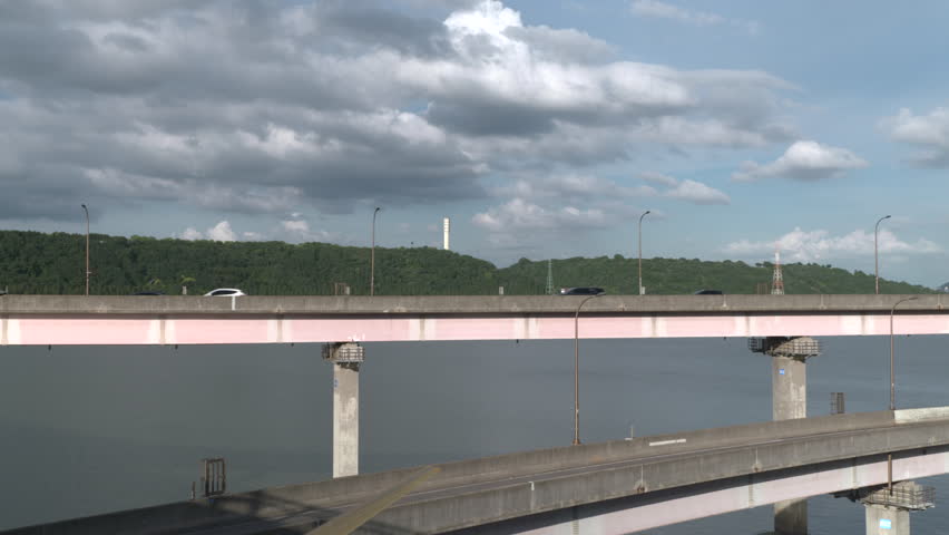 Vehicles driving on an elevated roadway over a river