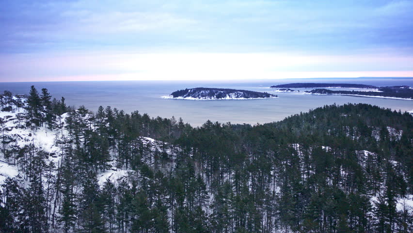Aerial drone view of snow-covered countryside in northern Michigan during winter.