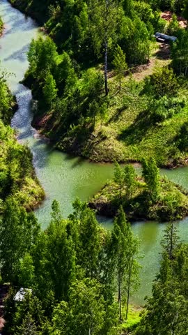 Lush green woodland and island set in tranquil blue lake water.