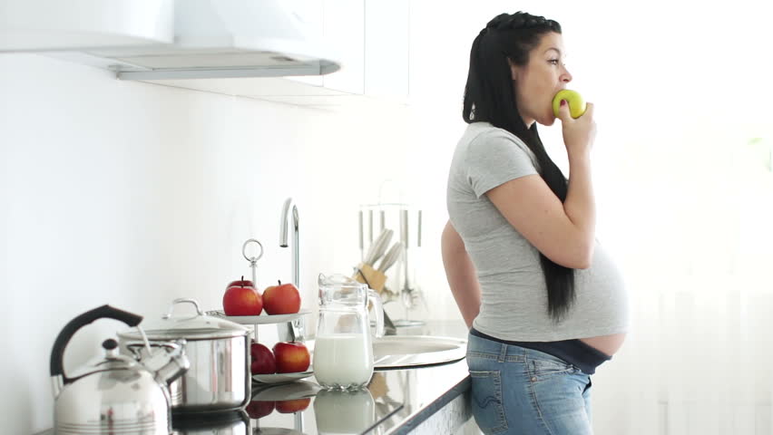Woman eating apple and thinking about something
