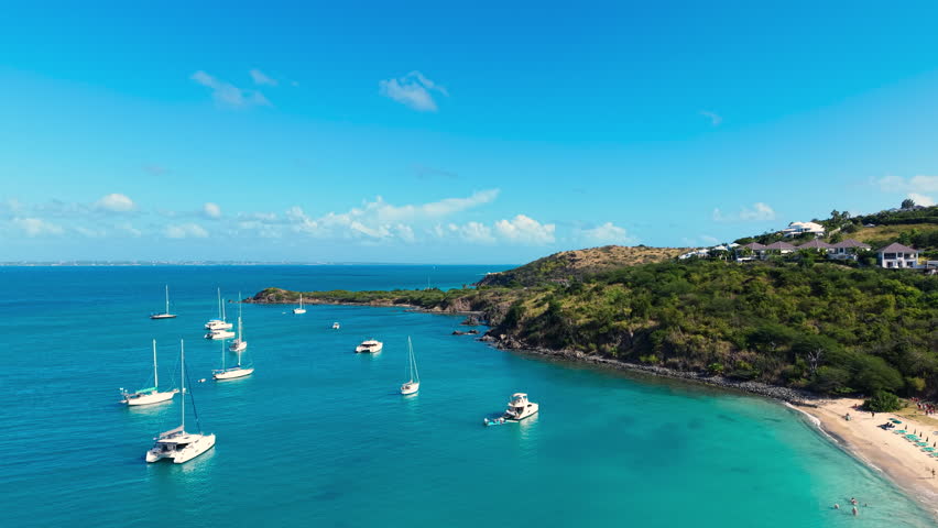 Drone view of sailboats and catamarans anchored in a calm tropical bay near Friar