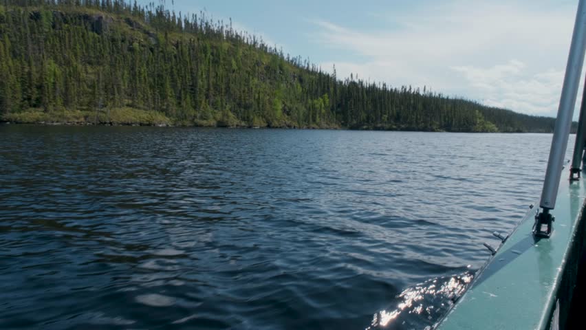 A scenic ride across a remote Canadian lake with waves and wilderness all around