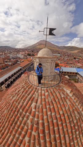 Tourist Standing on San Francisco Church Dome with Cerro Rico Mountain Background in Potosi, Bolivia