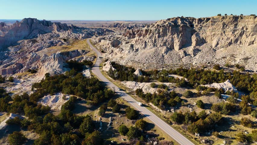 Aerial Drone Flight Over Colorful Eroded Rock Formations and Rugged Terrain in Badlands National Park South Dakota USA