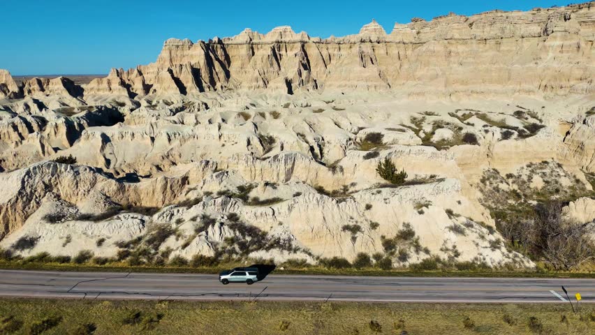 Aerial Drone Flight Over Colorful Eroded Rock Formations and Rugged Terrain in Badlands National Park South Dakota USA