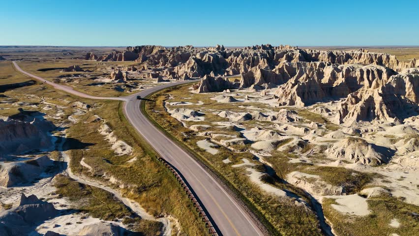 Aerial Drone Flight Over Colorful Eroded Rock Formations and Rugged Terrain in Badlands National Park South Dakota USA