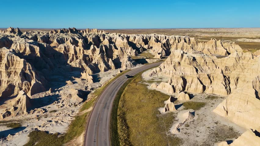 Aerial Drone Flight Over Colorful Eroded Rock Formations and Rugged Terrain in Badlands National Park South Dakota USA