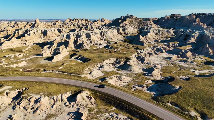Aerial Drone Flight Over Colorful Eroded Rock Formations and Rugged Terrain in Badlands National Park South Dakota USA