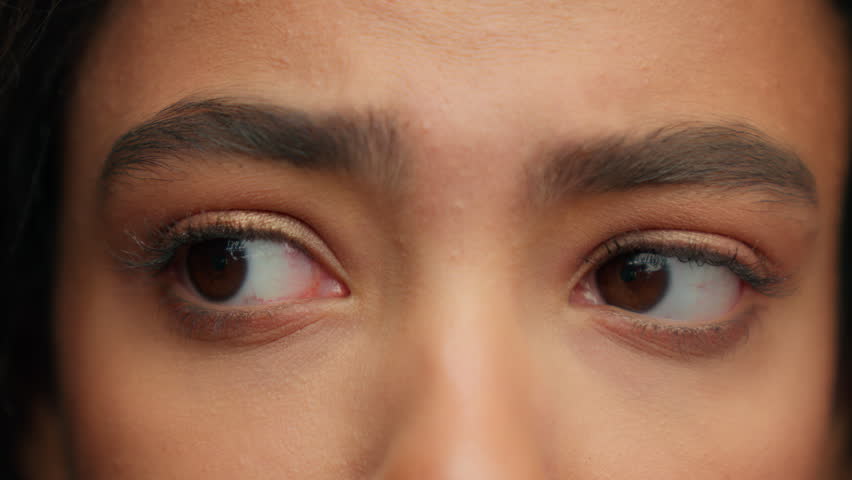 Close up sad upset female dark eyes looking around searching unrecognizable Latina Hispanic girl unknown woman look to side skin care eyesight health care sight vision medicine ophthalmology concept