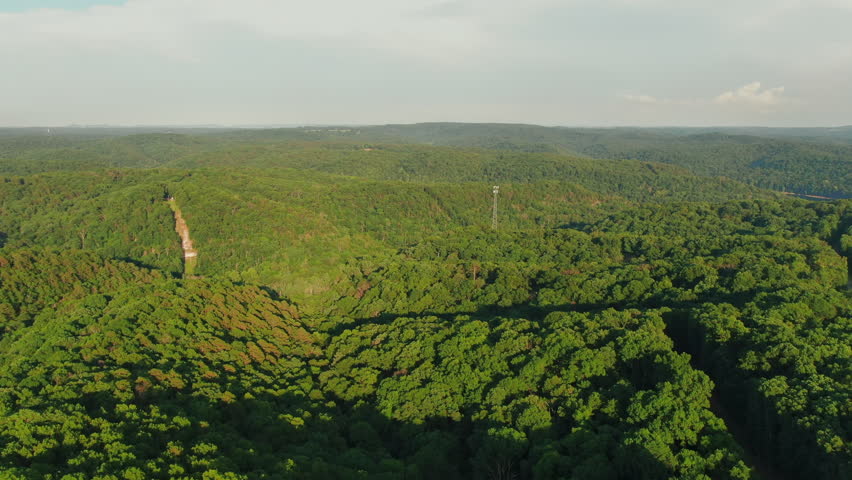 Aerial flying over woods in Ozark Mountains during golden hour, Arkansas, USA