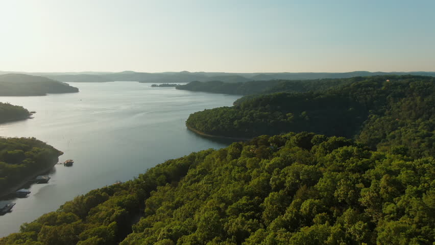 Establishing aerial shot flying over Beaver Lake natural shoreline, Arkansas, USA