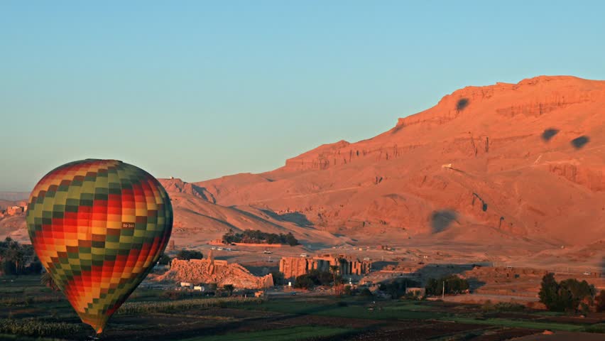 A hot air balloon preparing for touchdown over the West Bank of Luxor, Egypt.
