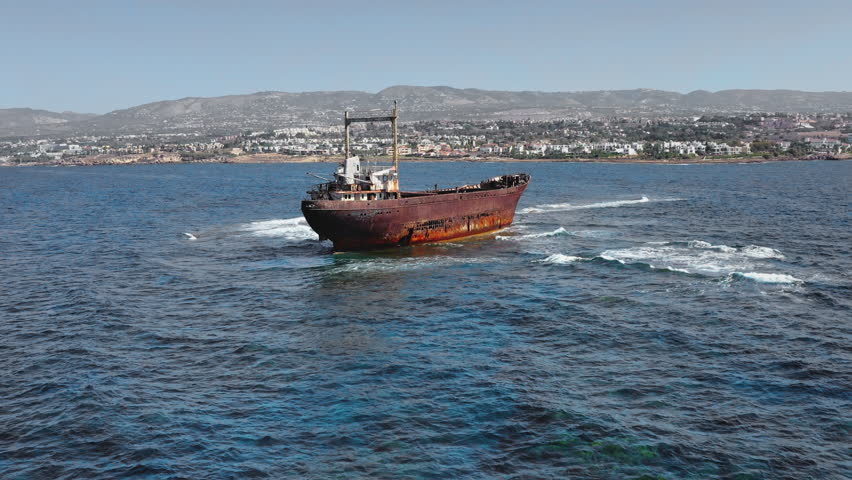 The forgotten Edro III cargo ship, now a tourist attraction, remains beached on the rocky coastline of Pegeia, Paphos, Cyprus, slowly corroding from exposure to the clear Mediterranean sea and sun