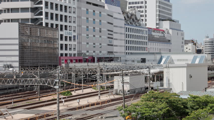 Tokyo Scene  :  Trains Departing from a Metropolitan Station Lined with Skyscrapers and Overflowing with Numerous Railway Lines  |  Ikebukuro Station, Tokyo, Japan