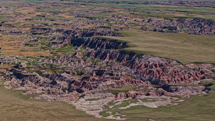 Aerial view of dramatic eroded colorful rock formations and badlands terrain near Badlands National Park, South Dakota