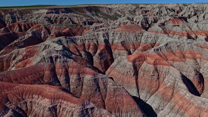 Aerial drone view of dramatic eroded rock formations and badlands terrain near Badlands National Park, South Dakota
