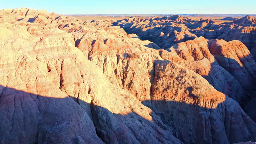 Colorful sunset landscape over dramatic rock formation peaks at Badlands National Park, South Dakota