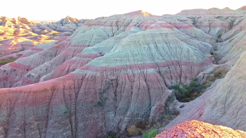 Colorful sunset landscape over dramatic rock formation peaks at Badlands National Park, South Dakota