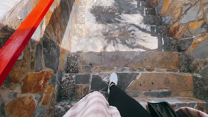 POV Walking Down Stone Steps With White Sneakers And Sunlit Rock Walls