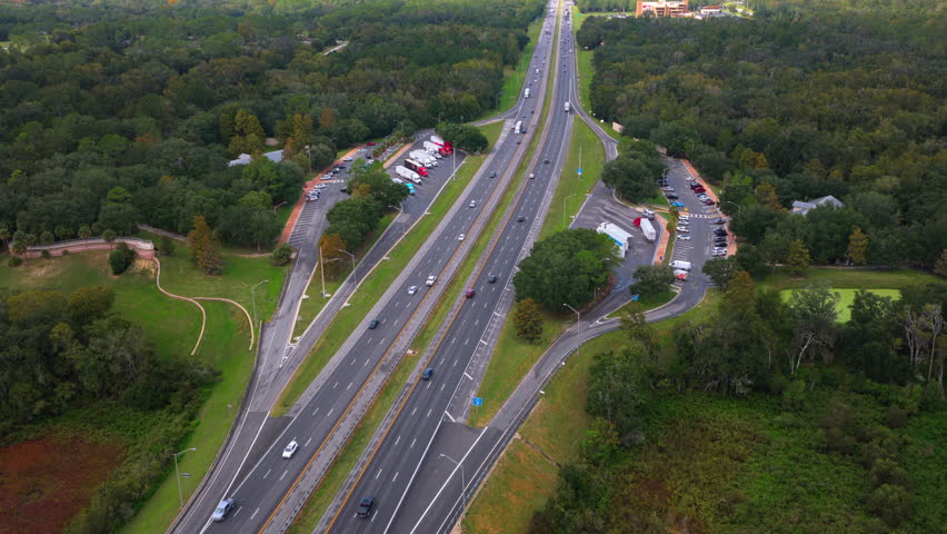 Truck stop at state welcome center near busy American interstate freeway. Parking for semi-trucks during interstate travel.