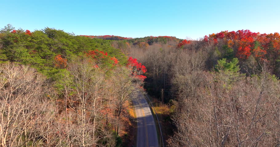 Blue Ridge Parkway in autumn. Mountain pass road between dense woods in seasonal colors in North Carolina.