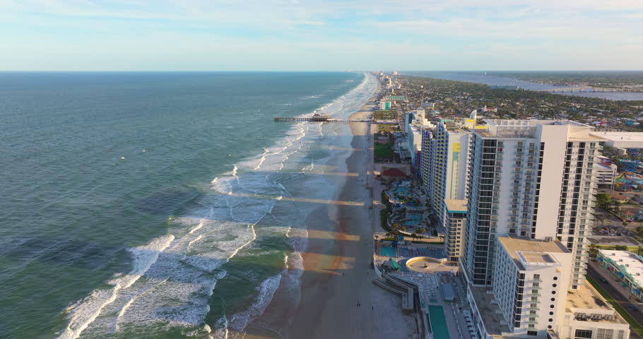Aerial view of Daytona Beach, Florida. American coastal city with luxury hotels, condos and tourist infrastructure along the sandy Atlantic shoreline.