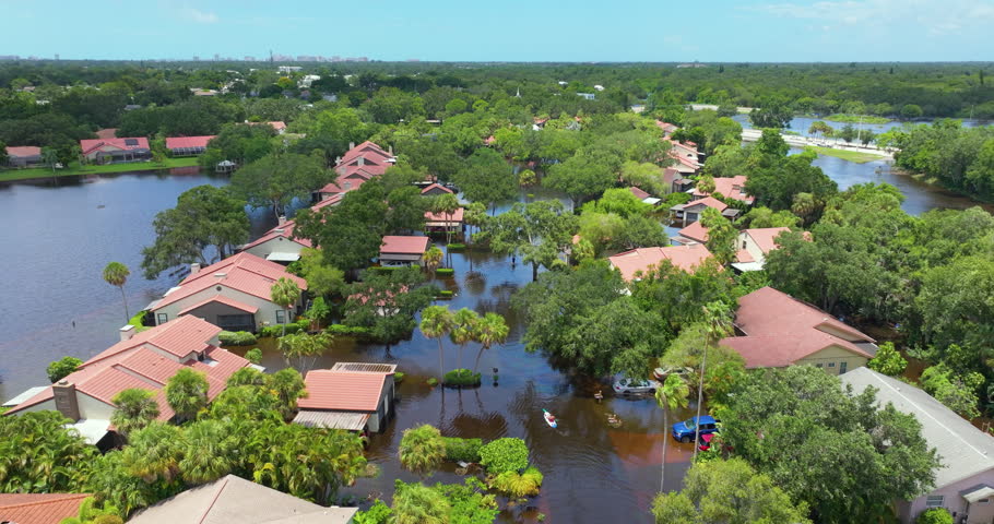 Flooding in Florida caused by tropical storm from hurricane rainfall. Suburb houses in residential community surrounded by flood waters. Aftermath of natural disaster