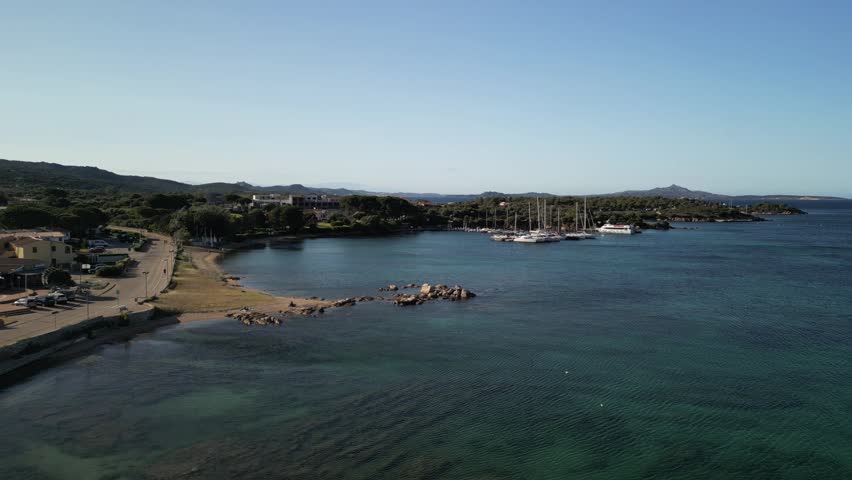 Laconia - Sardinia - Italy - Filmed with a drone. Sea, mountains, waves, Mediterranean climate, boats and beach, small town