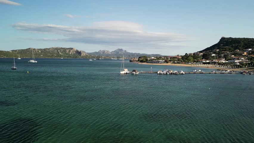 Laconia - Sardinia - Italy - Filmed with a drone. Sea, mountains, waves, Mediterranean climate, boats and beach, small town