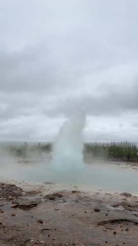 Strokkur geyser erupting in slow motion with steam and boiling water, Golden Circle, Iceland