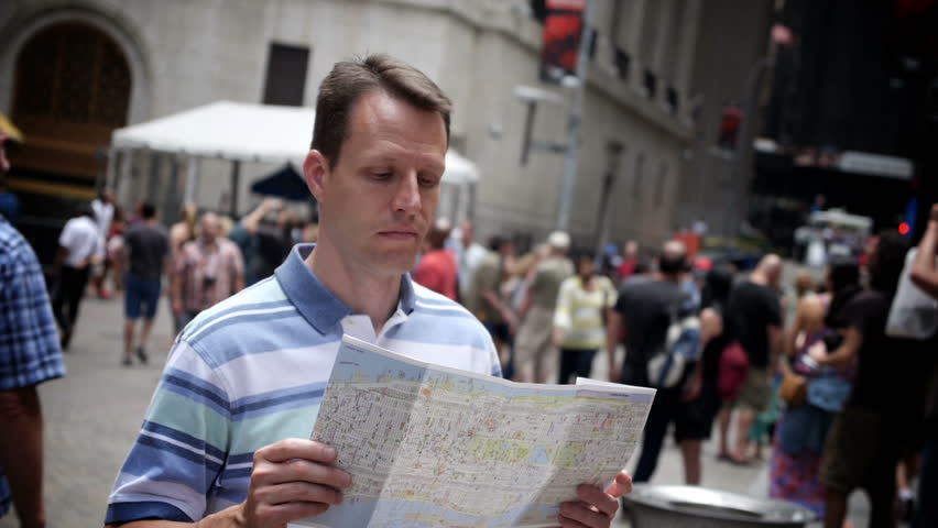 A man in the financial district in lower Manhattan looks at a map.