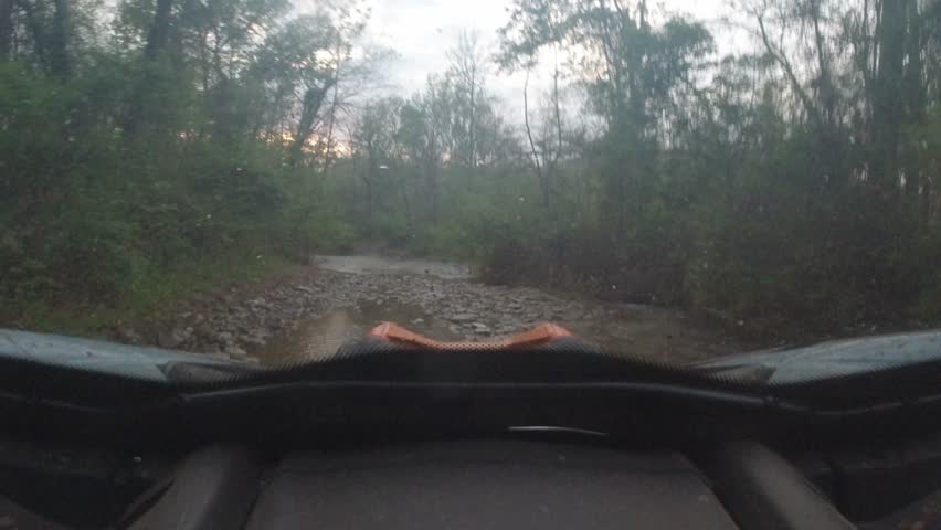 creek crossing in a UTV at twilight in the Ozark mountains
