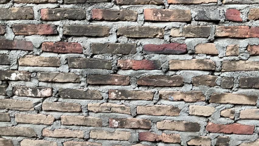 macro footage of a brick house wall in the afternoon